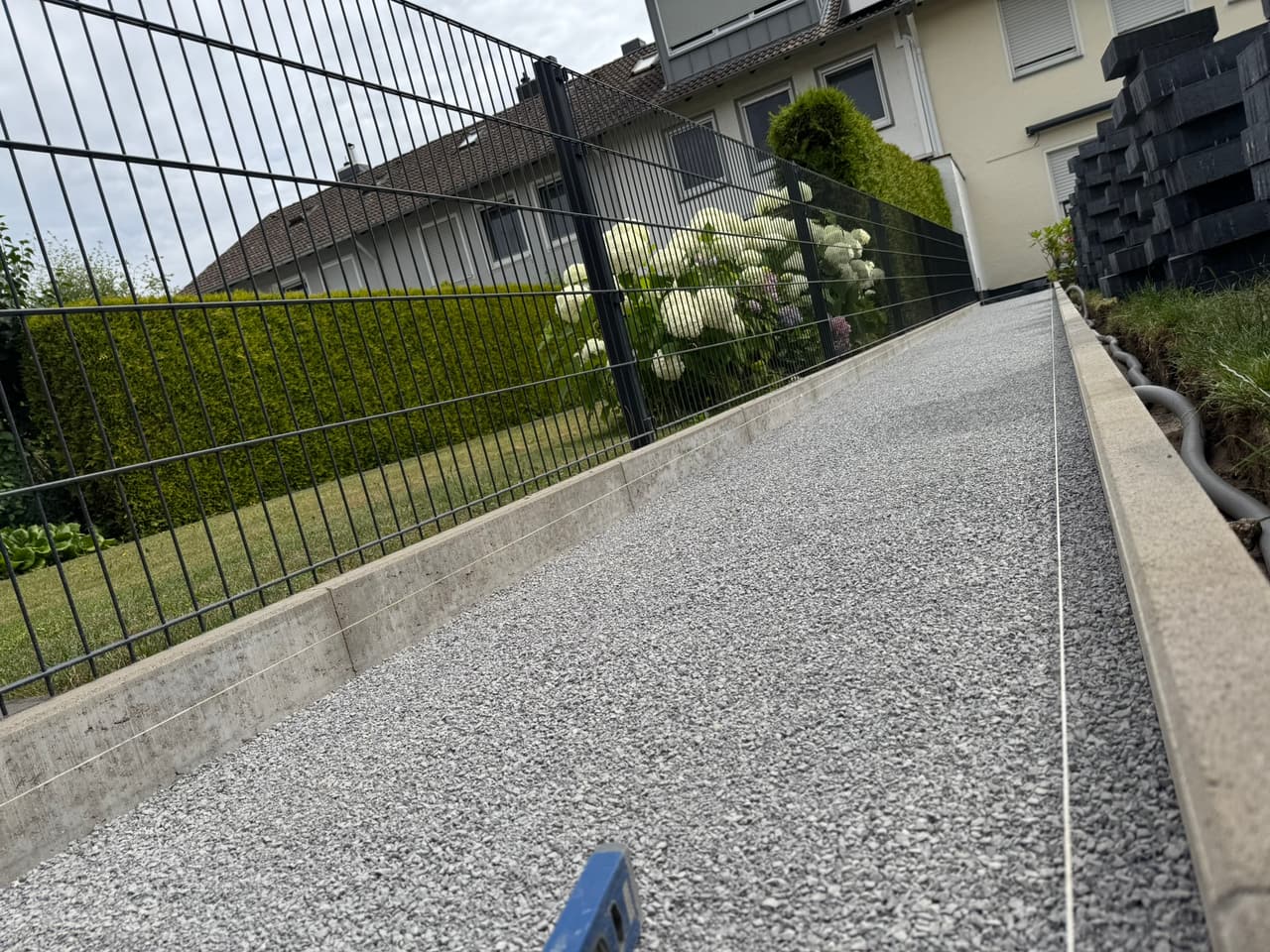 Pflasterarbeiten in Bielefeld - verdichtete Kiesfläche mit neuer Randeinfassung