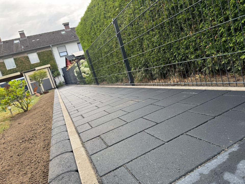 Doppelstabmattenzaun entlang eines gepflasterten Gartenwegs in Bielefeld